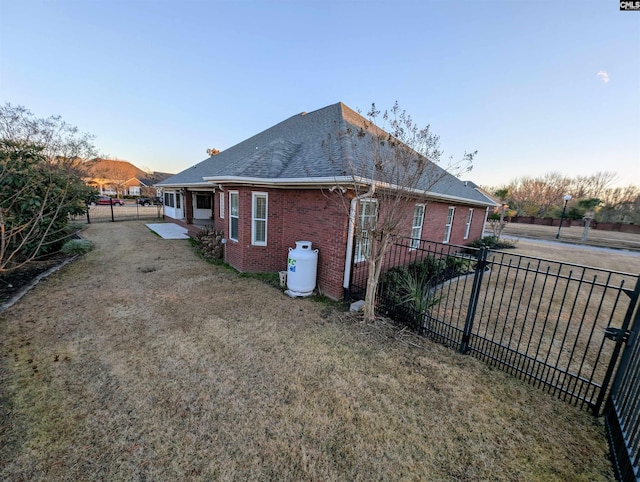 view of side of property with a lawn and a patio