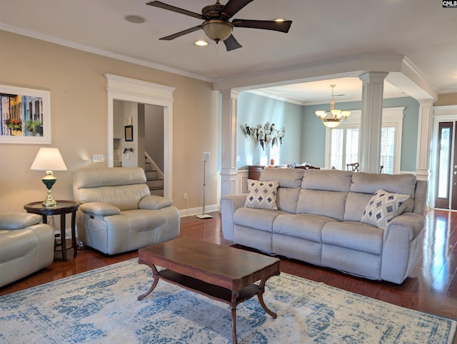 living room with decorative columns, ceiling fan with notable chandelier, crown molding, and dark hardwood / wood-style flooring