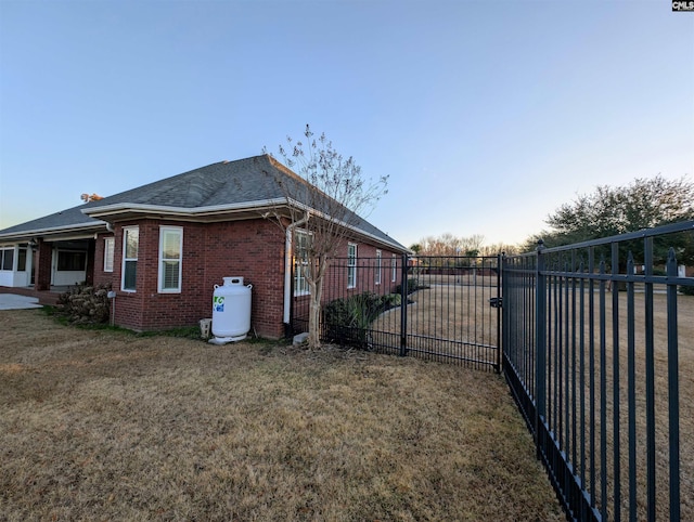 view of side of property with a lawn