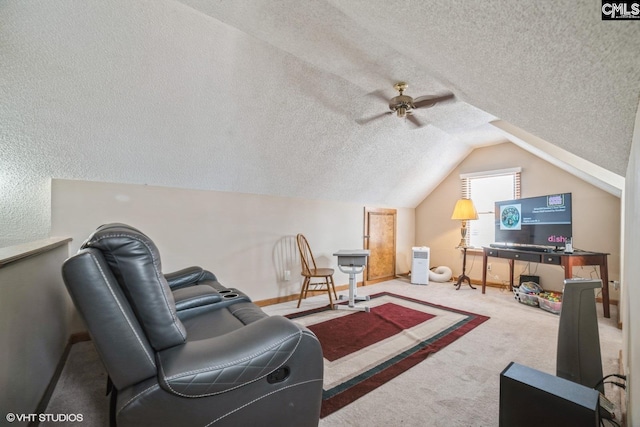 interior space featuring ceiling fan, vaulted ceiling, a textured ceiling, and carpet