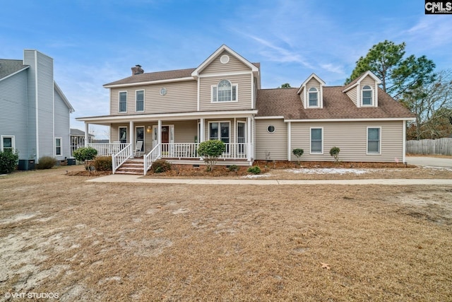 view of front of property featuring a porch, cooling unit, and a front lawn