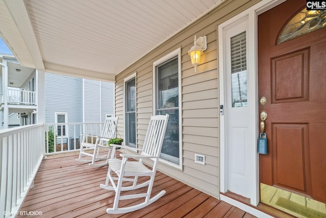 wooden terrace featuring covered porch