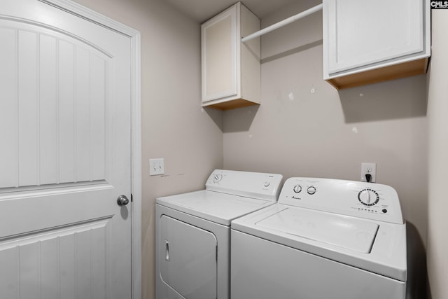 laundry room with cabinets and washing machine and dryer