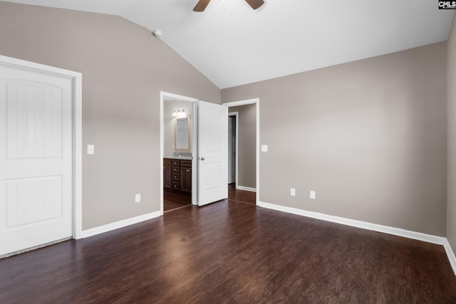 unfurnished bedroom with ceiling fan, vaulted ceiling, dark wood-type flooring, and ensuite bath