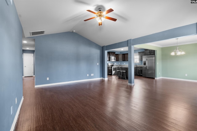 unfurnished living room featuring ceiling fan with notable chandelier, dark hardwood / wood-style floors, and vaulted ceiling