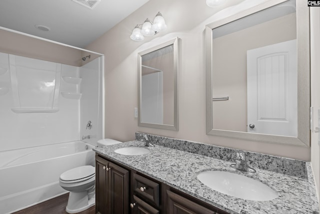 full bathroom featuring tub / shower combination, wood-type flooring, toilet, and vanity