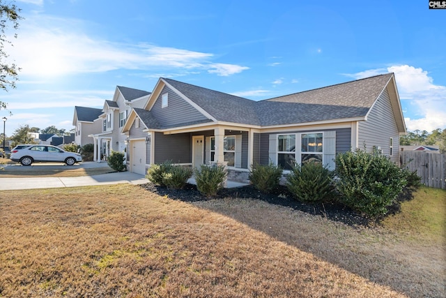 view of front of property with a front yard and a garage