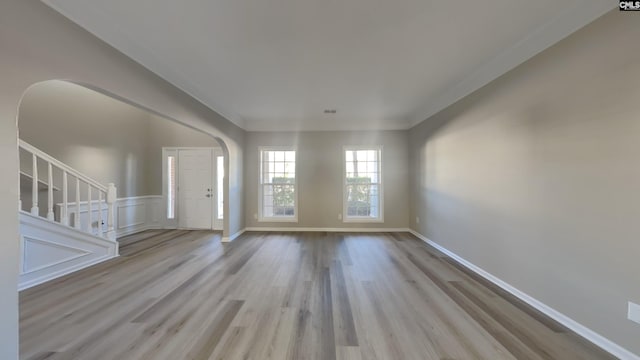 foyer entrance featuring light wood-type flooring and ornamental molding