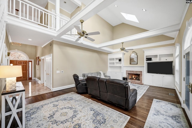 106 Stonebrook Dr, Blythewood, SC 29016 - living room with dark wood-type flooring, a high ceiling, built in shelves, and ceiling fan