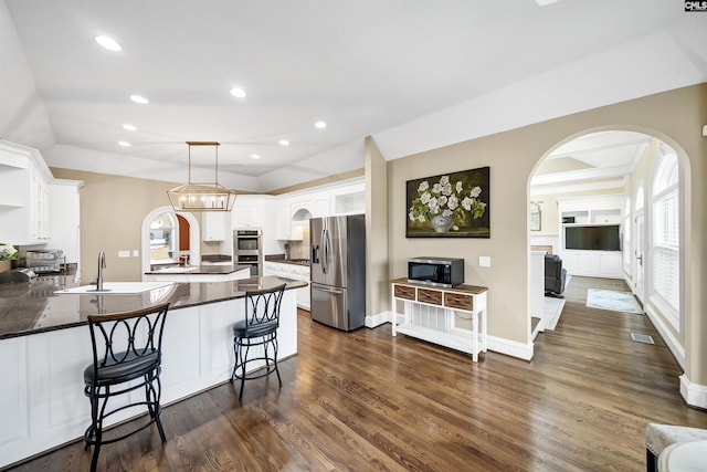 106 Stonebrook Dr, Blythewood, SC 29016 - kitchen with pendant lighting, white cabinets, appliances with stainless steel finishes, a kitchen bar, and kitchen peninsula