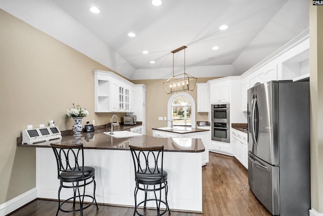 106 Stonebrook Dr, Blythewood, SC 29016 - kitchen with appliances with stainless steel finishes, white cabinetry, hanging light fixtures, kitchen peninsula, and a breakfast bar area