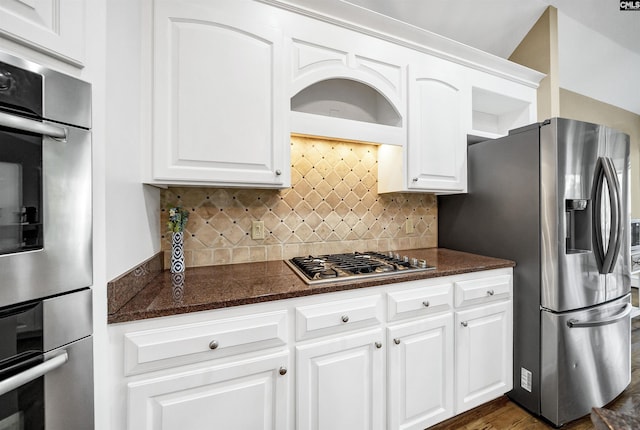 106 Stonebrook Dr, Blythewood, SC 29016 - kitchen featuring appliances with stainless steel finishes, white cabinetry, decorative backsplash, dark hardwood / wood-style flooring, and dark stone counters