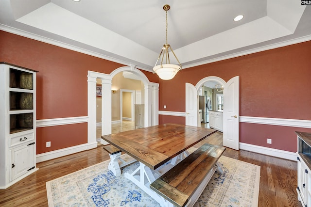 106 Stonebrook Dr, Blythewood, SC 29016 - dining room with decorative columns, hardwood / wood-style flooring, a tray ceiling, and ornamental molding