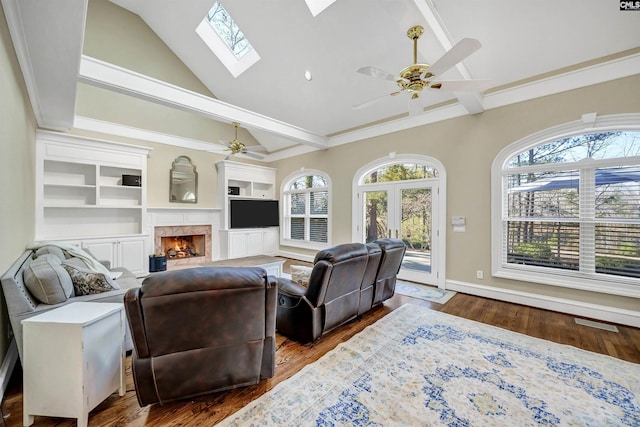 106 Stonebrook Dr, Blythewood, SC 29016 - living room featuring ceiling fan, built in shelves, dark hardwood / wood-style floors, and a skylight