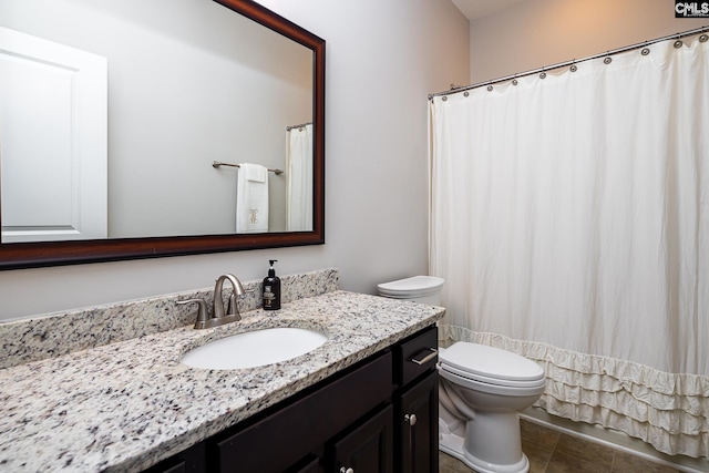 bathroom with tile patterned floors, vanity, and toilet