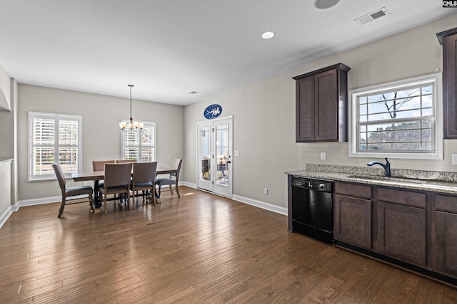 kitchen featuring dark brown cabinets, black dishwasher, sink, and dark hardwood / wood-style floors