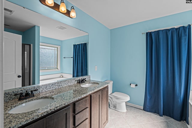 bathroom featuring a tub to relax in, vanity, toilet, and tile patterned flooring