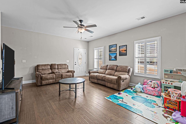 living room with ceiling fan and dark hardwood / wood-style flooring