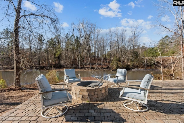 view of patio with a water view and a fire pit