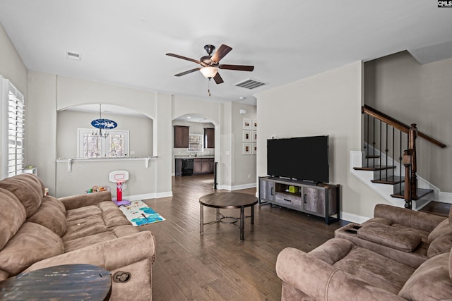 living room featuring dark hardwood / wood-style floors and ceiling fan