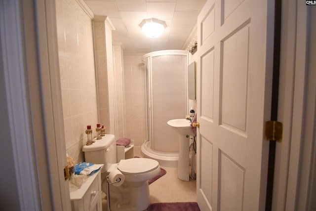 bathroom with toilet and a shower with door