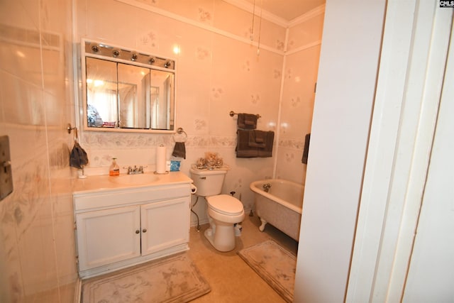 bathroom with ornamental molding, vanity, toilet, and a bathtub