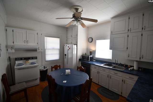 kitchen featuring sink, white appliances, dark hardwood / wood-style flooring, ceiling fan, and white cabinets