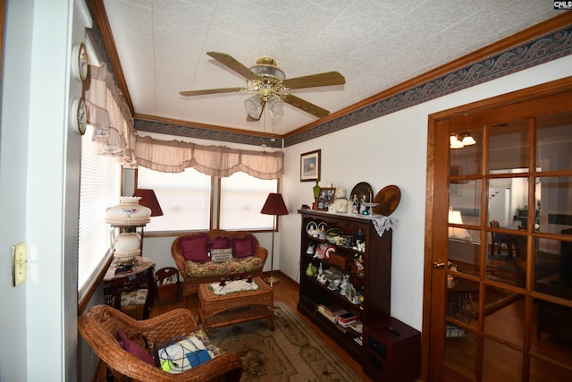 sitting room featuring ornamental molding and ceiling fan