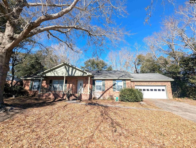 ranch-style home featuring a garage and covered porch