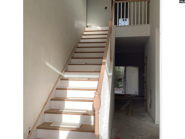 staircase with concrete floors