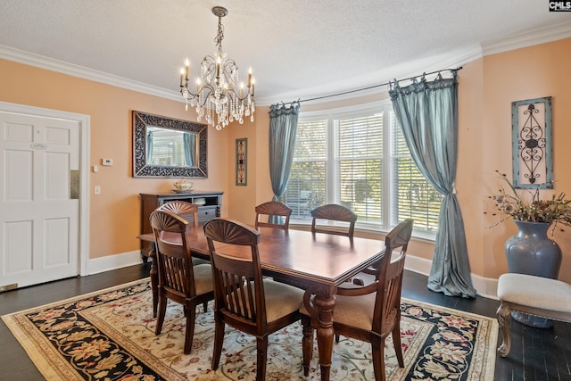 dining room featuring a textured ceiling, dark hardwood / wood-style flooring, ornamental molding, and a chandelier