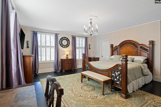 bedroom featuring crown molding, an inviting chandelier, and dark wood-type flooring