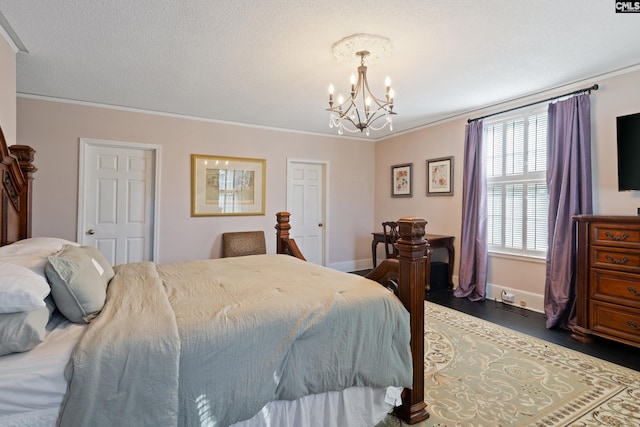 bedroom featuring dark hardwood / wood-style flooring, crown molding, and a chandelier