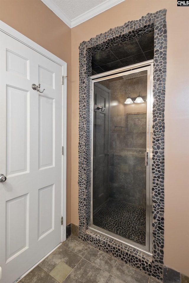 bathroom featuring a shower with shower door and ornamental molding