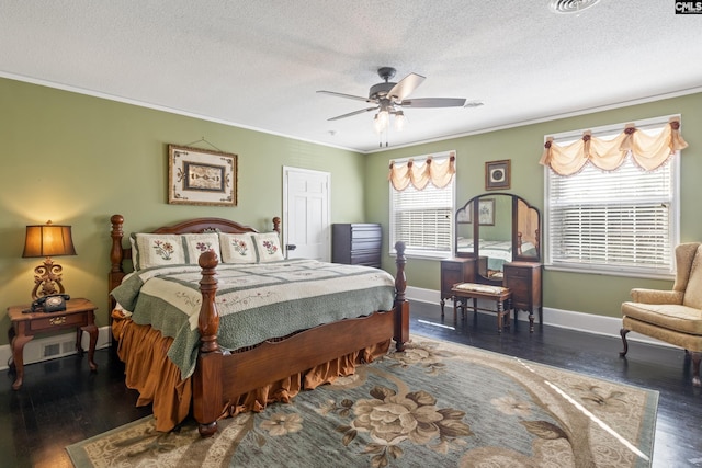 bedroom featuring ceiling fan, crown molding, dark hardwood / wood-style floors, and a textured ceiling