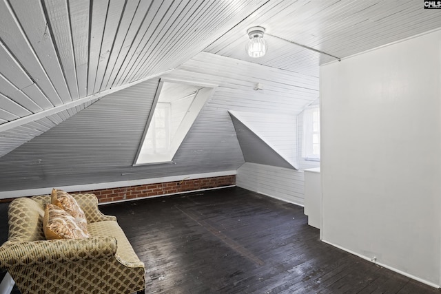 additional living space with vaulted ceiling and dark hardwood / wood-style floors