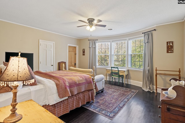 bedroom with ceiling fan, a textured ceiling, dark hardwood / wood-style flooring, and crown molding