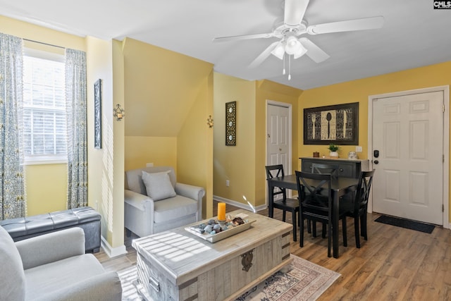 living room featuring ceiling fan and wood-type flooring