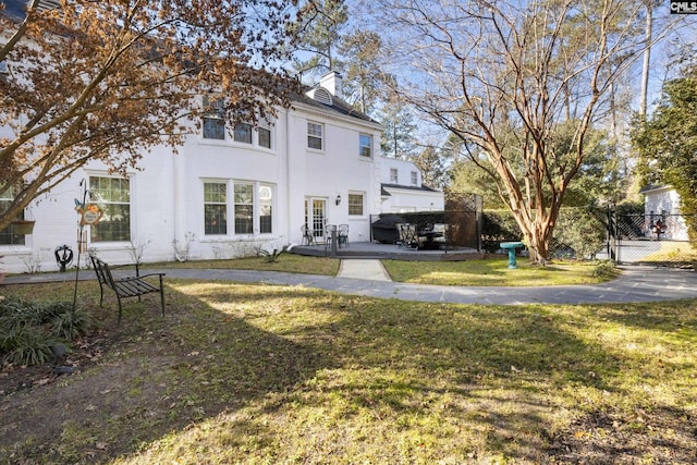 rear view of house featuring a lawn