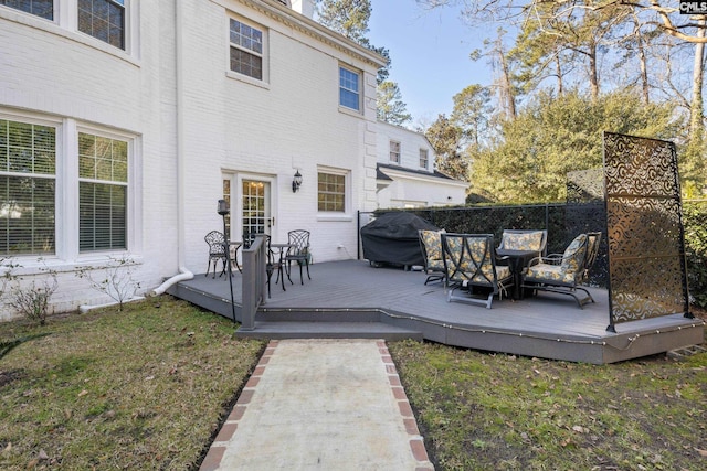wooden deck with a grill and a yard
