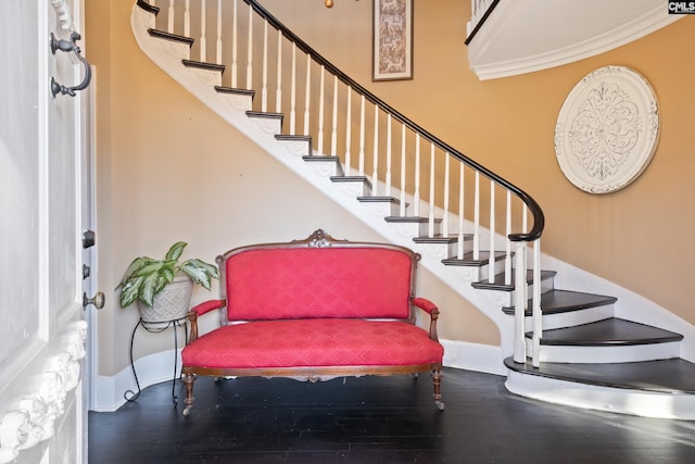 staircase featuring crown molding and hardwood / wood-style flooring