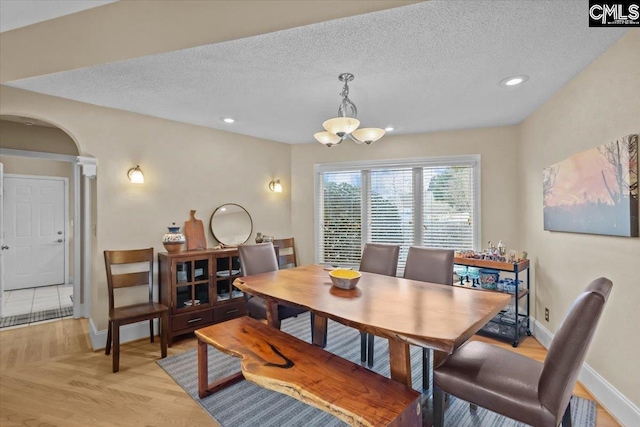 dining room featuring a chandelier and a textured ceiling