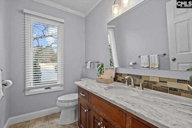 bathroom featuring ornamental molding, toilet, decorative backsplash, and a wealth of natural light