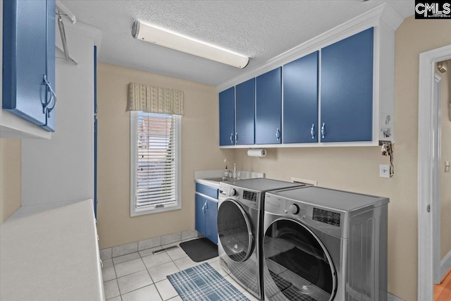 laundry room with sink, washer and clothes dryer, cabinets, ornamental molding, and light tile patterned flooring