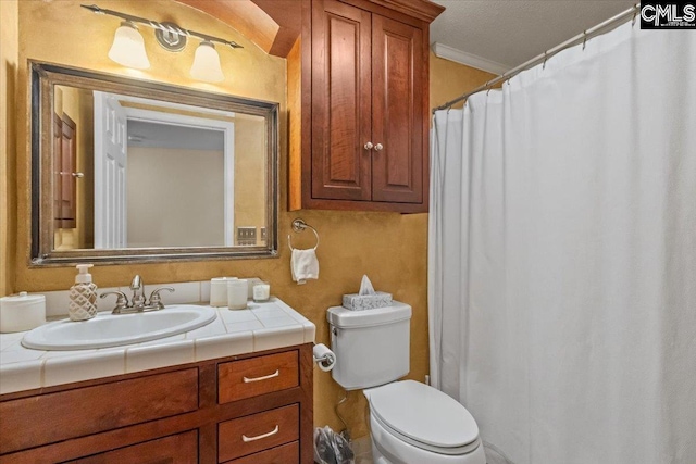 bathroom featuring ornamental molding, toilet, vanity, and a textured ceiling