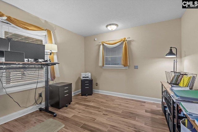 office area with wood-type flooring and a textured ceiling