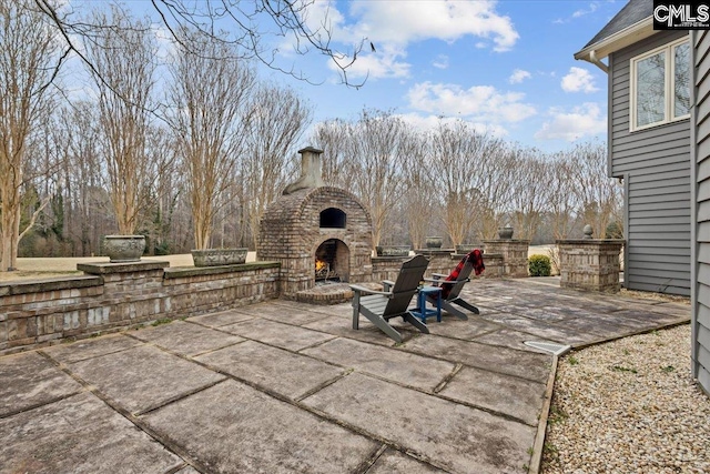 view of patio featuring an outdoor fireplace