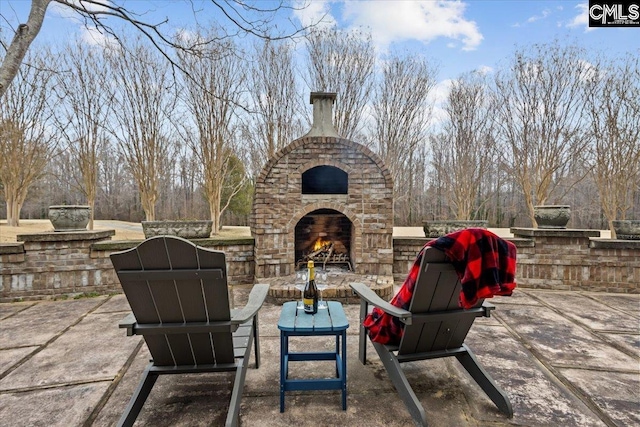 view of patio / terrace featuring an outdoor stone fireplace