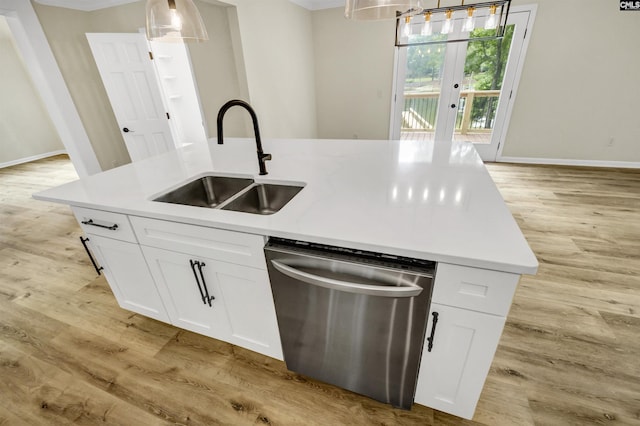 kitchen with sink, stainless steel dishwasher, a kitchen island with sink, and white cabinets