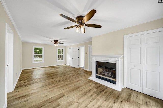 unfurnished living room featuring crown molding and light wood-type flooring